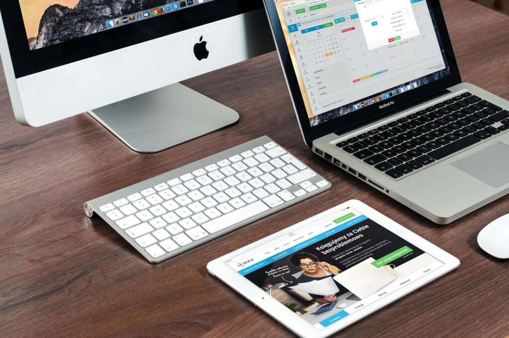 What to Learn in Tech in 2025: Beginner’s Guide to Top Careers 5 A sleek office desk setup featuring Apple devices: iMac, MacBook, and iPad.